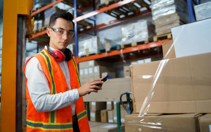 Portrait of a young worker of a logistics warehouse